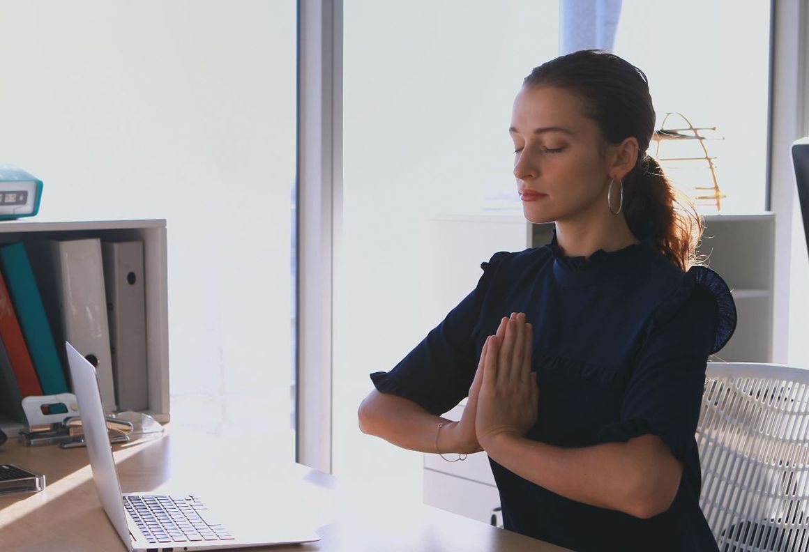 Woman meditating at her desk